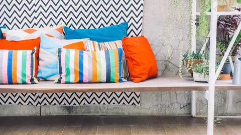 Patio outdoor deck with colorful pillow on chair decoration exterior of home - Vintage light filter